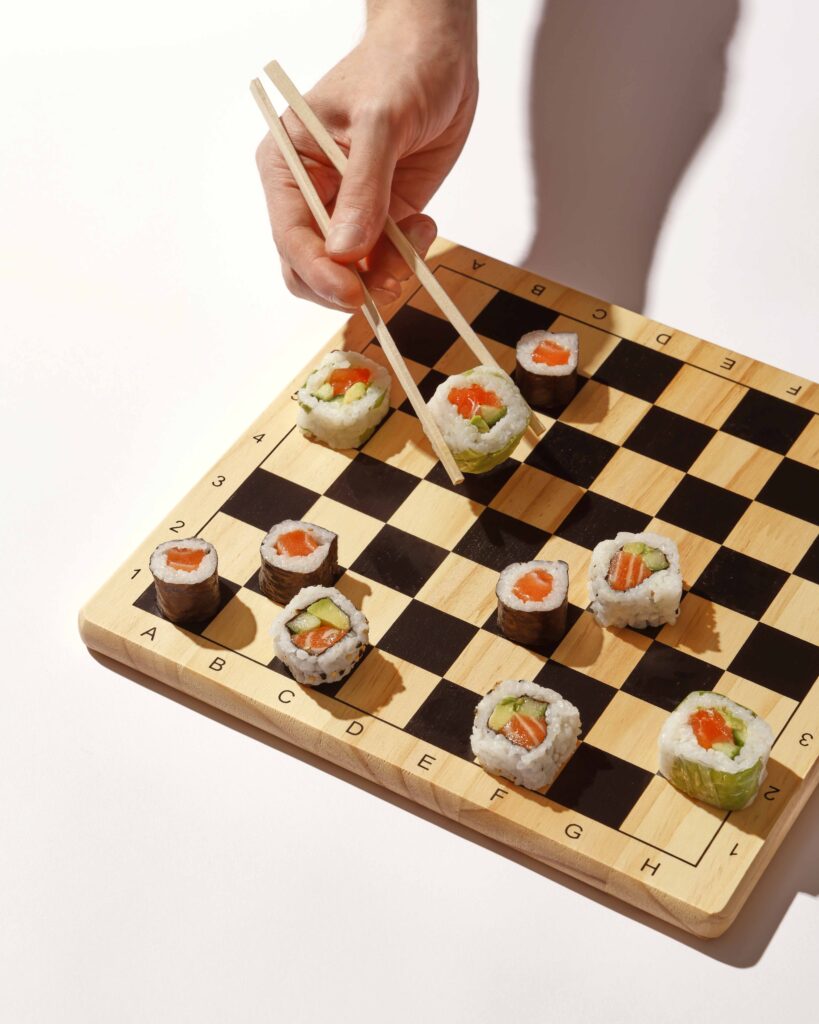 Een schaakbord met sushi's als pionnen. Beeld van Simon van Rhee. Contrast in marketing voor slimme differentiatie.